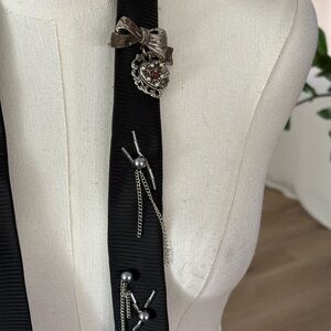 Black Ribbon Brooch with Silver Accents